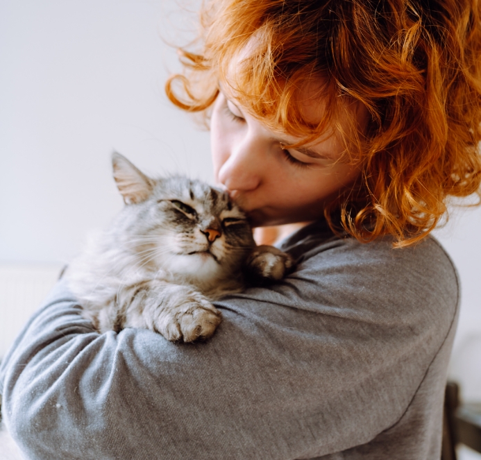 Woman kissing cat